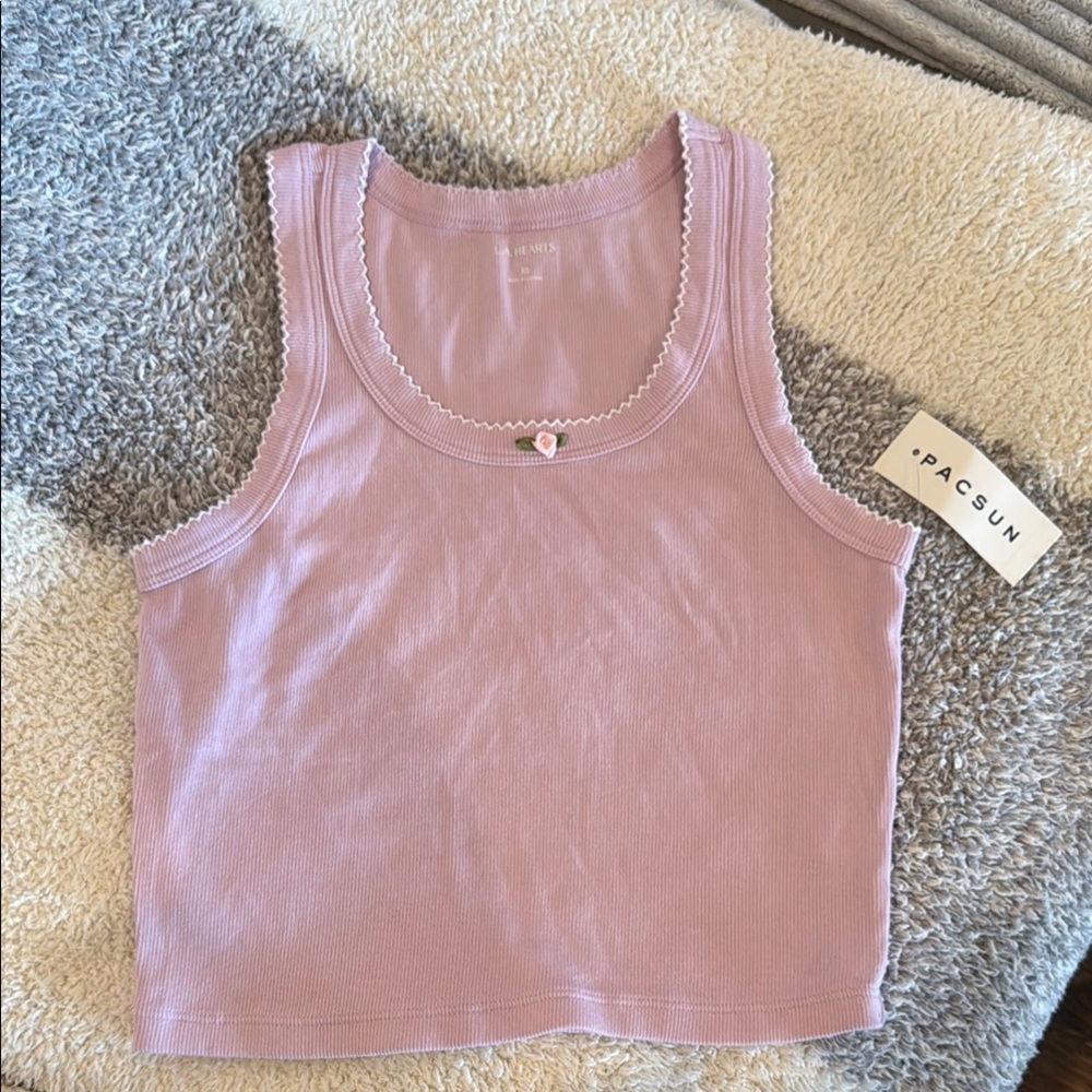 Brand new PacSun tank top with flower embellishment. Super cute!